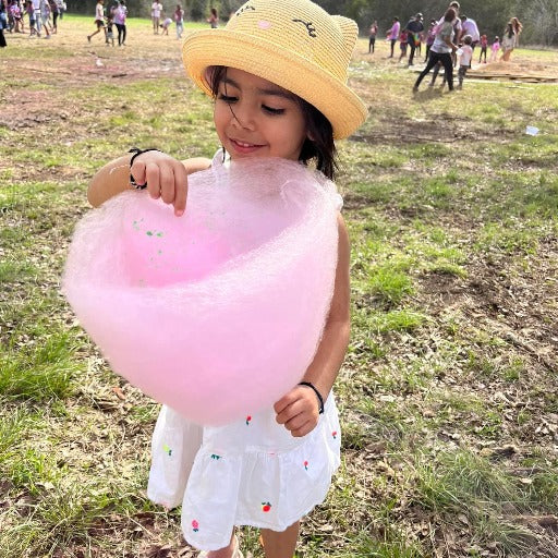 Little girl enjoying Cotton Candy Cowgirls cotton candy.
