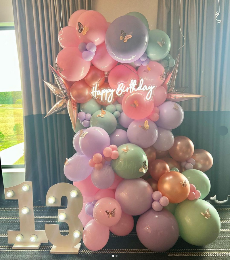 pastel pink, green, and purple balloon decor for a thirteen year old