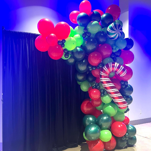 christmas holiday themed red and green balloon decor with candy cane balloon