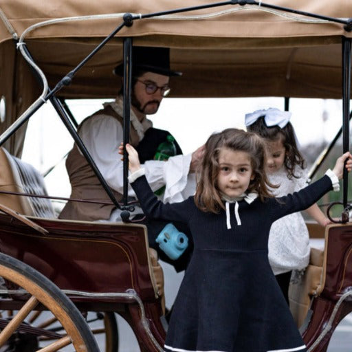 Children arrive by horse drawn carriage to a Dickensian themed holiday party by Marvelous Events USA