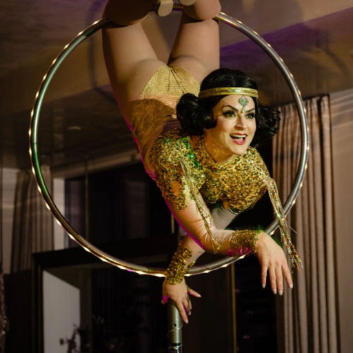 A circus perform hangs from the ceiling at a birthday party in Austin by Marvelous Events USA